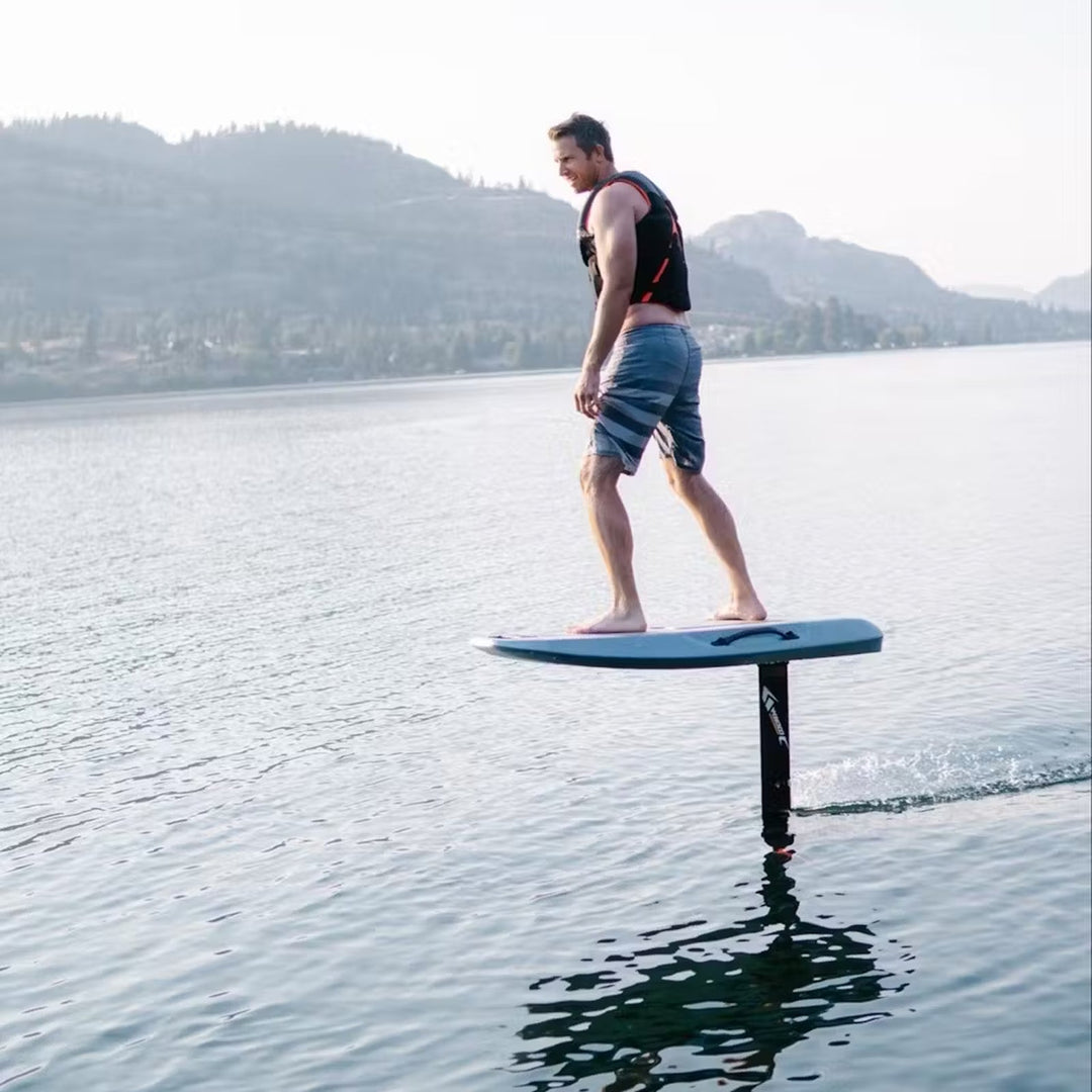Rider wearing a PFD while eFoiling on a calm mountain lake